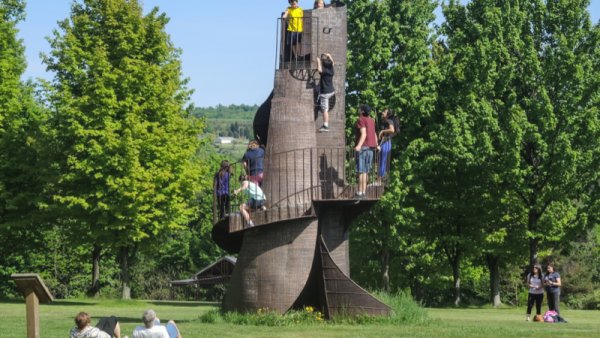 People climbing the "tower" at Griffis Sculpture Park in the summertime
